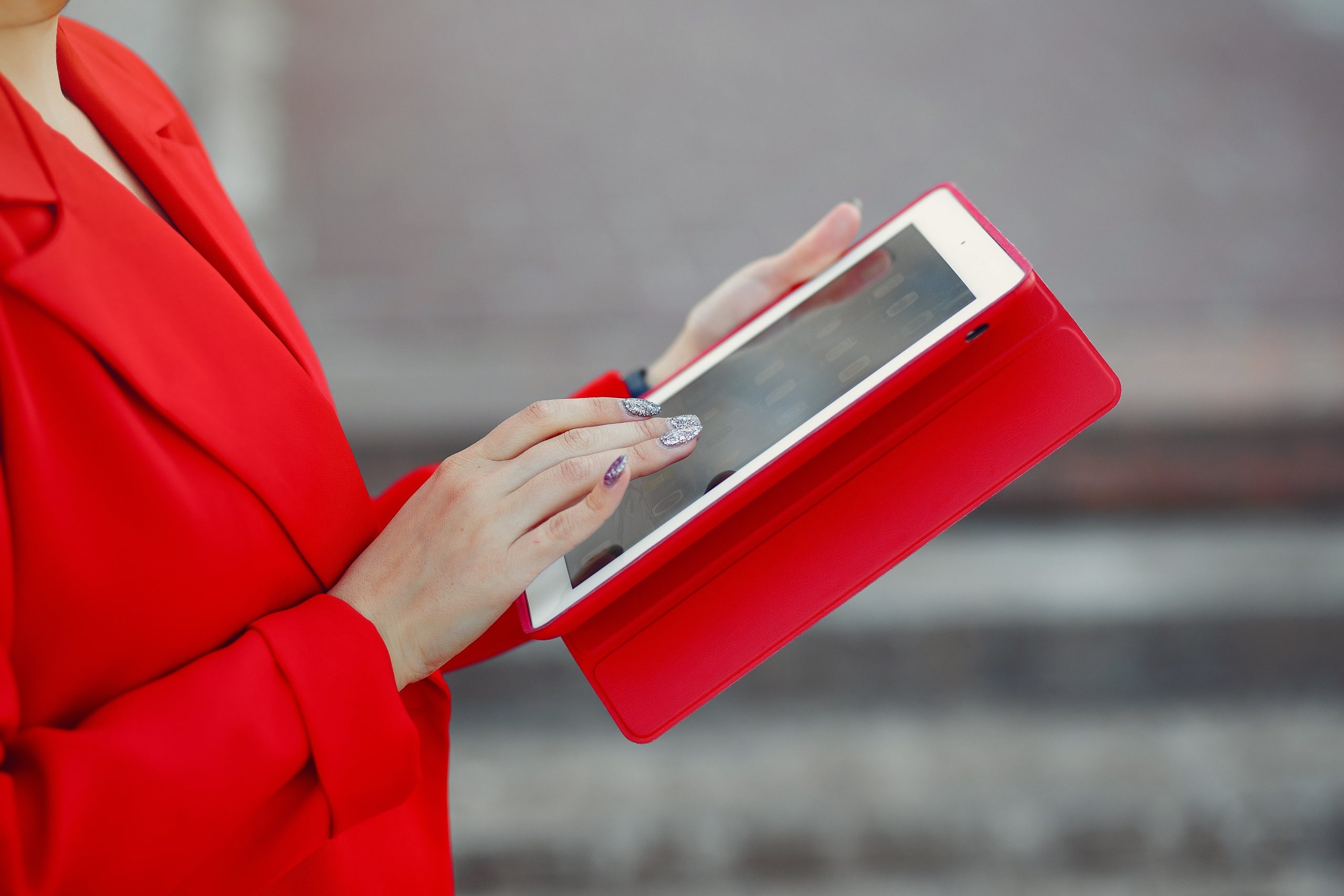woman-red-jacket-using-tablet
